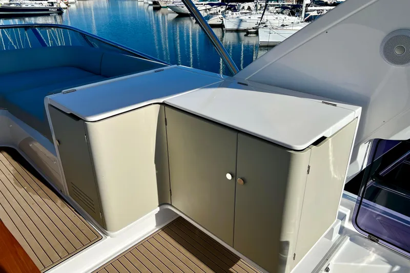  Yacht Photos Pics 2024 Azimut Fly 60 yacht deck with sleek cabinetry and seating, docked at marina.