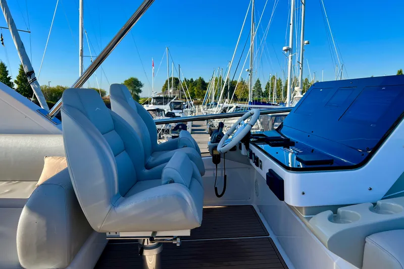  Yacht Photos Pics 2024 Azimut Fly 60 yacht helm with luxurious seating and modern controls at marina.