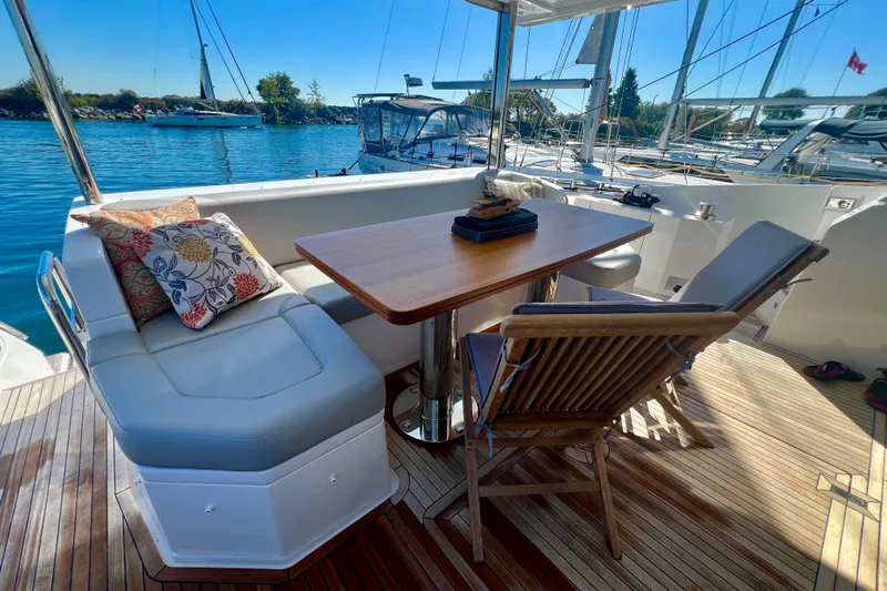  Yacht Photos Pics Luxurious 2024 Azimut Fly 60 yacht deck with elegant seating and scenic marina view.