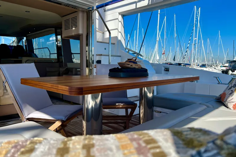  Yacht Photos Pics Luxurious 2024 Azimut Fly 60 yacht interior with elegant seating and marina view.