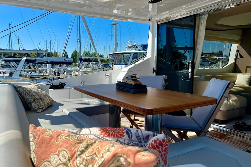  Yacht Photos Pics Luxurious 2024 Azimut Fly 60 yacht interior with elegant seating and marina view.