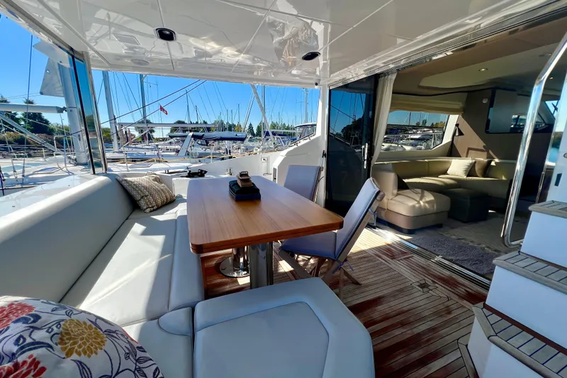  Yacht Photos Pics Luxurious 2024 Azimut Fly 60 yacht interior with elegant seating and wooden table.