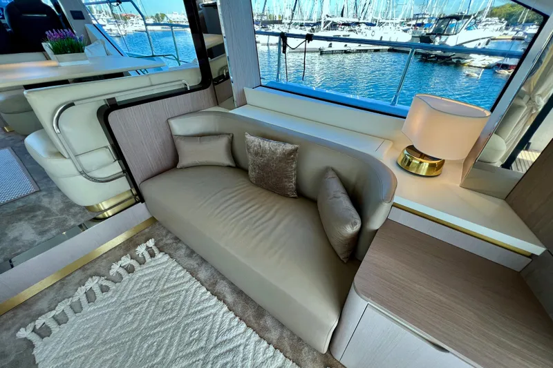  Yacht Photos Pics Luxurious interior of 2024 Azimut Fly 60 yacht with elegant seating and marina view.