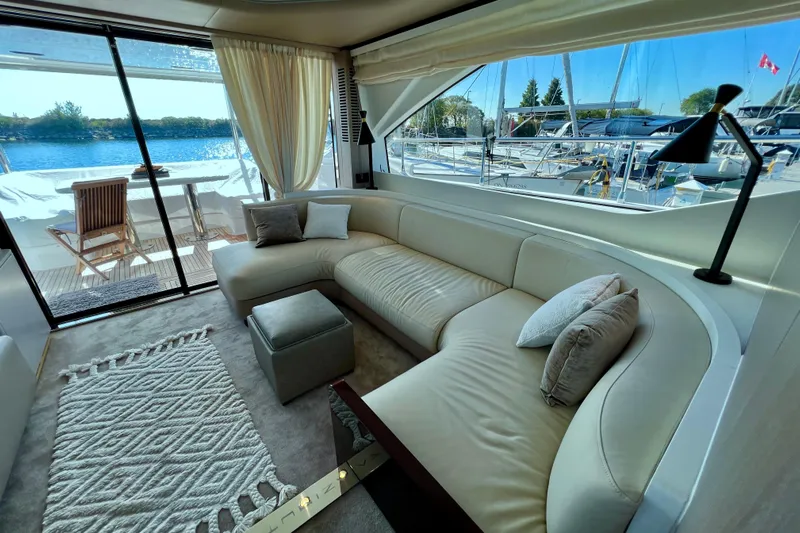  Yacht Photos Pics Luxurious interior of 2024 Azimut Fly 60 yacht with elegant seating and scenic marina view.