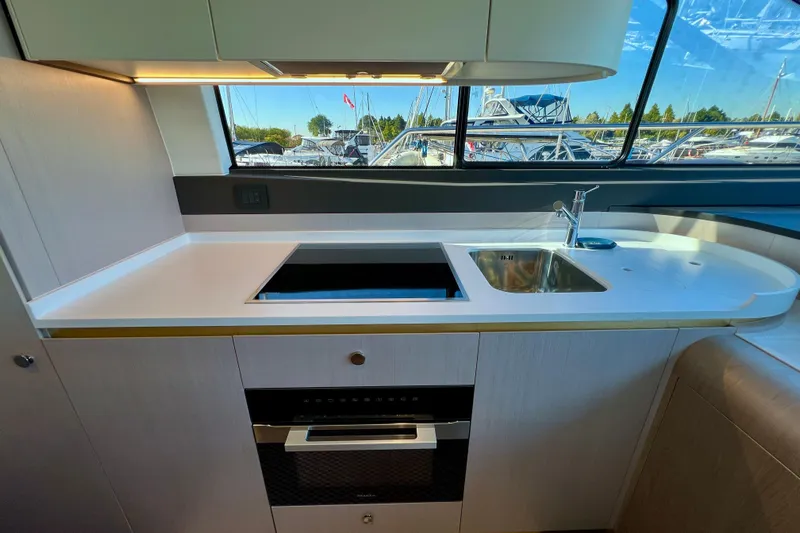  Yacht Photos Pics Modern kitchen interior on 2024 Azimut Fly 60 yacht with sleek design and appliances.