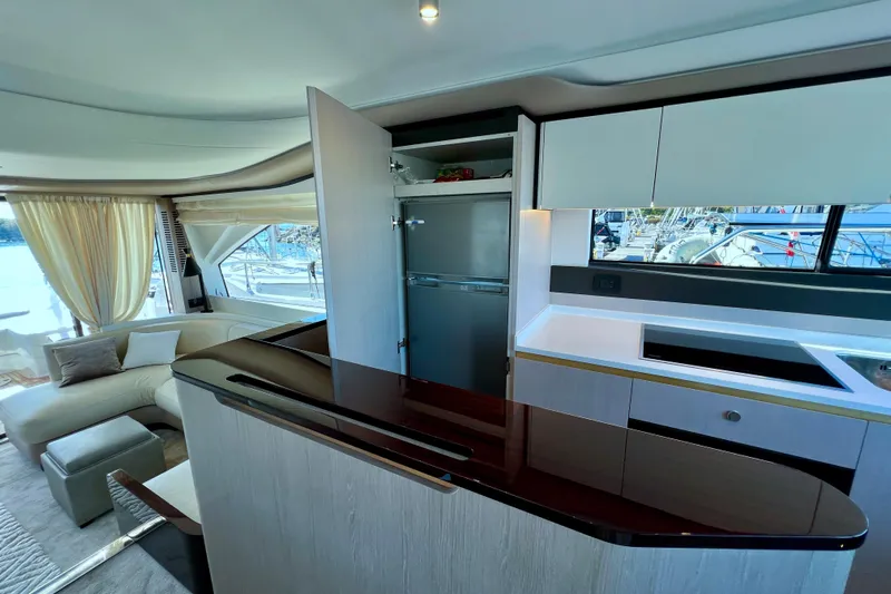  Yacht Photos Pics Luxurious interior of 2024 Azimut Fly 60 yacht with modern kitchen and seating area.