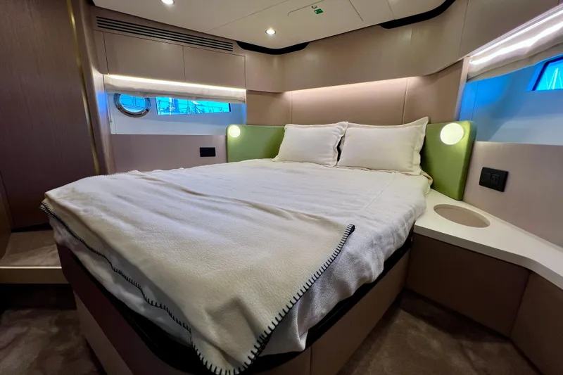  Yacht Photos Pics Luxurious bedroom interior of 2024 Azimut Fly 60 yacht with modern design and cozy bedding.