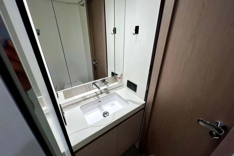  Yacht Photos Pics Modern bathroom interior on 2024 Azimut Fly 60 yacht, featuring sleek sink and mirror.