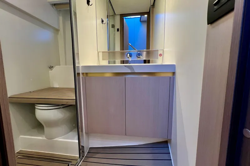  Yacht Photos Pics Luxurious bathroom interior of 2024 Azimut Fly 60 yacht, featuring modern fixtures and wooden accents.