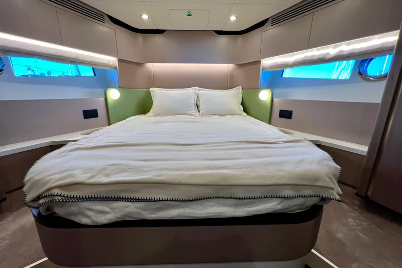  Yacht Photos Pics Luxurious bedroom interior of 2024 Azimut Fly 60 yacht with modern design and cozy bedding.