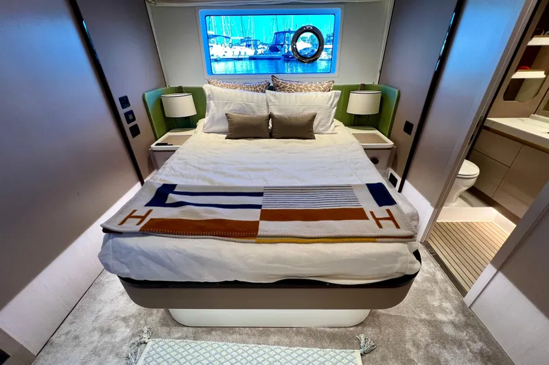  Yacht Photos Pics Luxurious bedroom interior of 2024 Azimut Fly 60 yacht with elegant decor and window view.