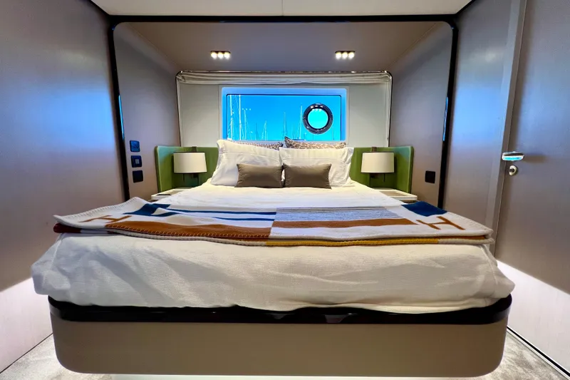  Yacht Photos Pics Luxurious bedroom interior of 2024 Azimut Fly 60 yacht with modern design and cozy bedding.