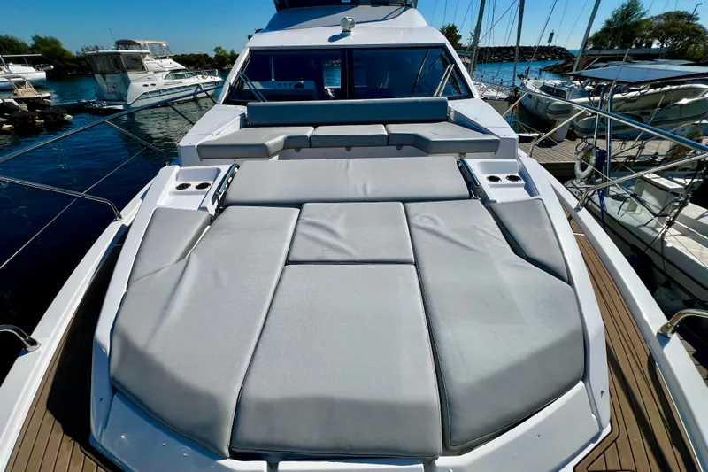  Yacht Photos Pics 2024 Azimut Fly 60 yacht with spacious sunbathing deck in marina setting.