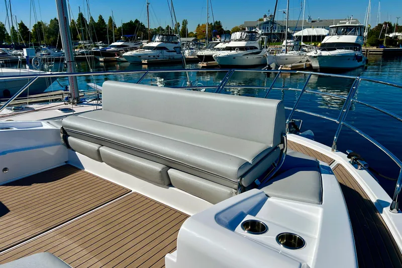  Yacht Photos Pics 2024 Azimut Fly 60 yacht with sleek seating and elegant deck design in marina setting.