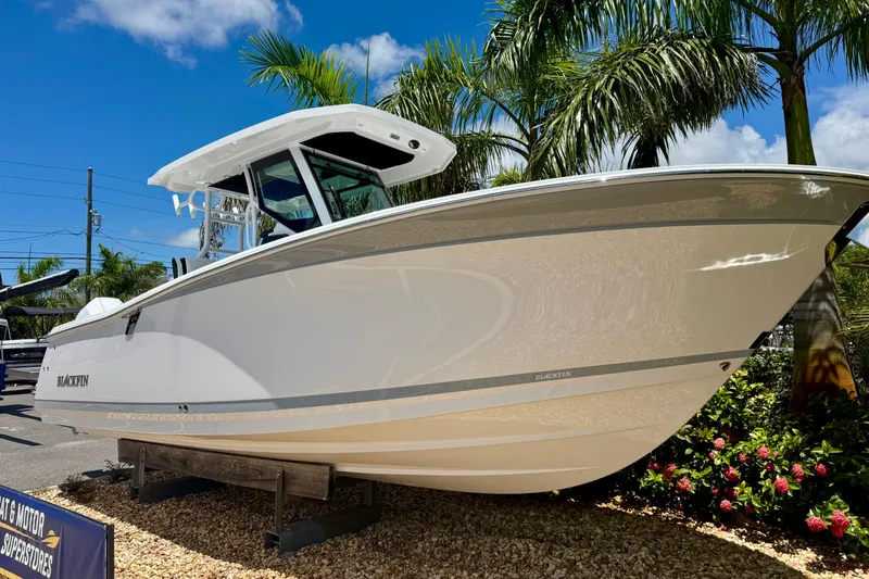  Yacht Photos Pics 2026 Blackfin 272 CC boat displayed outdoors with palm trees and blue sky.