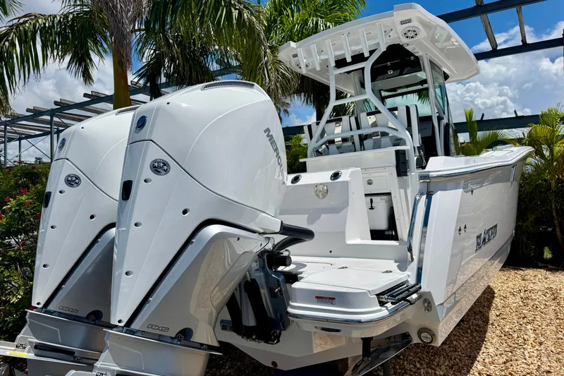  Yacht Photos Pics 2026 Blackfin 272 CC boat with dual Mercury engines, set against a tropical backdrop.
