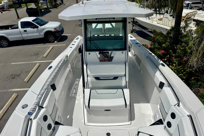  Yacht Photos Pics 2026 Blackfin 272 CC boat, sleek design, spacious deck, parked outdoors.