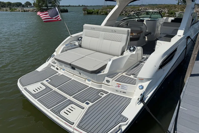  Yacht Photos Pics 2020 Sea Ray SLX 350 boat docked, featuring spacious seating and American flag.