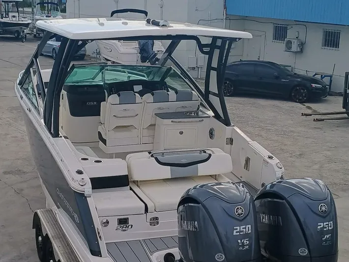 280-101 Yacht Photos Pics 2024 Chaparral 280 OSX boat with dual Yamaha 250 engines, docked in a marina.