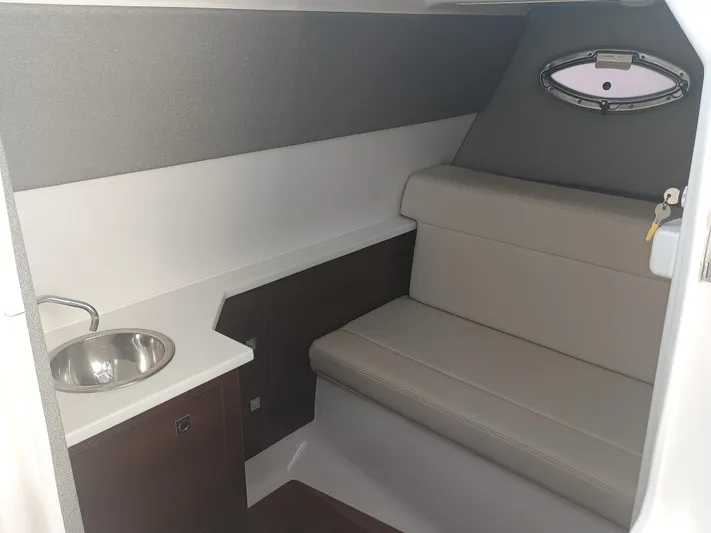 280-101 Yacht Photos Pics 2024 Chaparral 280 OSX cabin interior with seating and sink.