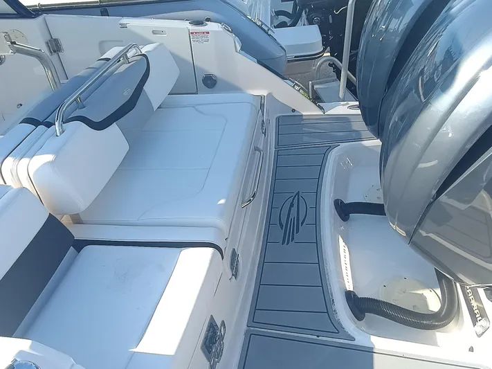 280-101 Yacht Photos Pics 2024 Chaparral 280 OSX boat interior with seating and engine area.
