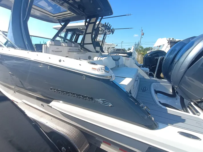 280-101 Yacht Photos Pics 2024 Chaparral 280 OSX boat with sleek design and powerful engines, docked outdoors.