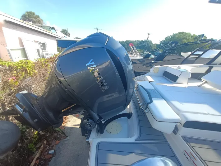 280-101 Yacht Photos Pics 2024 Chaparral 280 OSX boat with Yamaha outboard motor, docked outdoors.