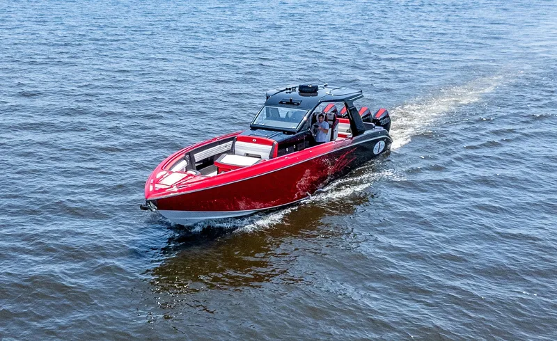  Yacht Photos Pics 2025 Cigarette 41 Nighthawk boat cruising on open water, red and black design.