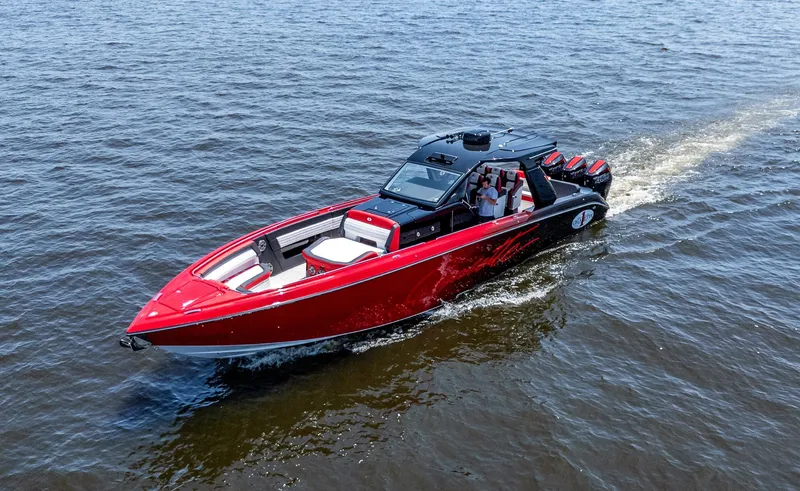  Yacht Photos Pics 2025 Cigarette 41 Nighthawk speedboat cruising on open water, featuring sleek red and black design.