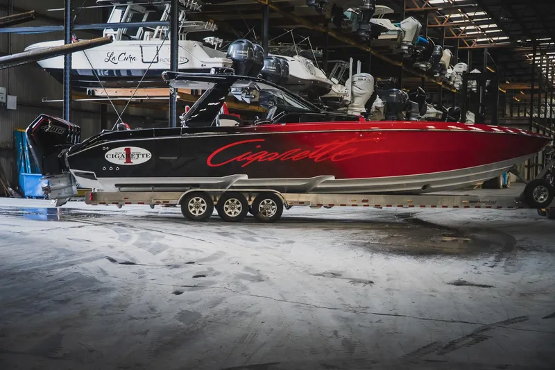  Yacht Photos Pics 2025 Cigarette 41 Nighthawk boat in storage, featuring sleek red and black design.