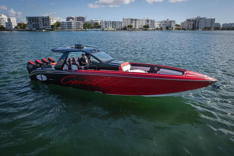  Yacht Photos Pics 2025 Cigarette 41 Nighthawk speedboat on water, red and black design, cityscape background.