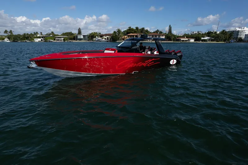  Yacht Photos Pics 2025 Cigarette 41 Nighthawk boat on water, red exterior, clear sky, coastal background.