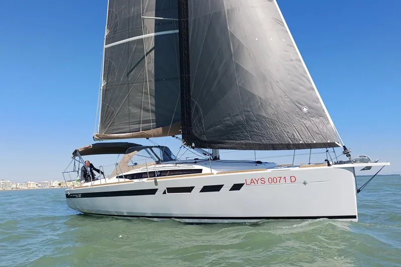 Prima Yacht Photos Pics 2024 Jeanneau Sun Odyssey 349 sailing on open water under clear blue sky.