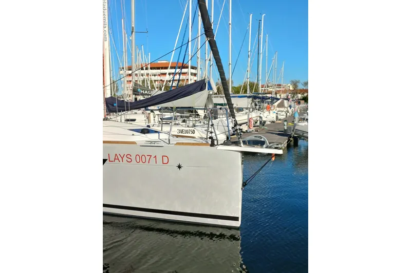 Prima Yacht Photos Pics 2024 Jeanneau Sun Odyssey 349 sailboat docked in a marina, clear blue sky.