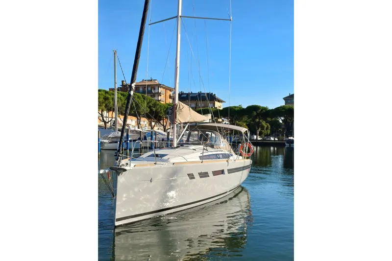 Prima Yacht Photos Pics 2024 Jeanneau Sun Odyssey 349 sailboat docked in a serene marina setting.