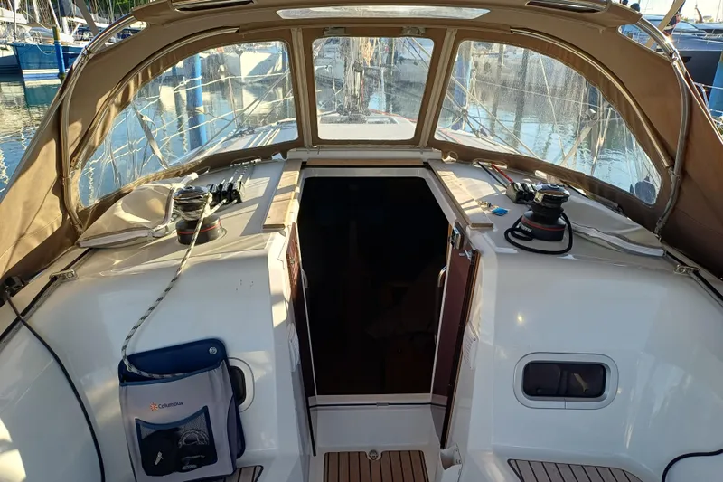 Prima Yacht Photos Pics 2024 Jeanneau Sun Odyssey 349 cockpit with winches and canopy, docked at marina.
