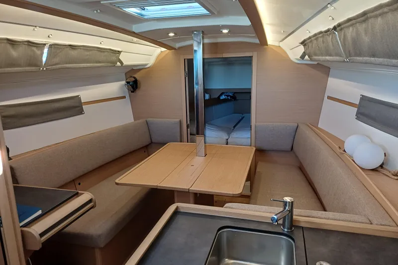 Prima Yacht Photos Pics 2024 Jeanneau Sun Odyssey 349 interior with cozy seating and modern design.