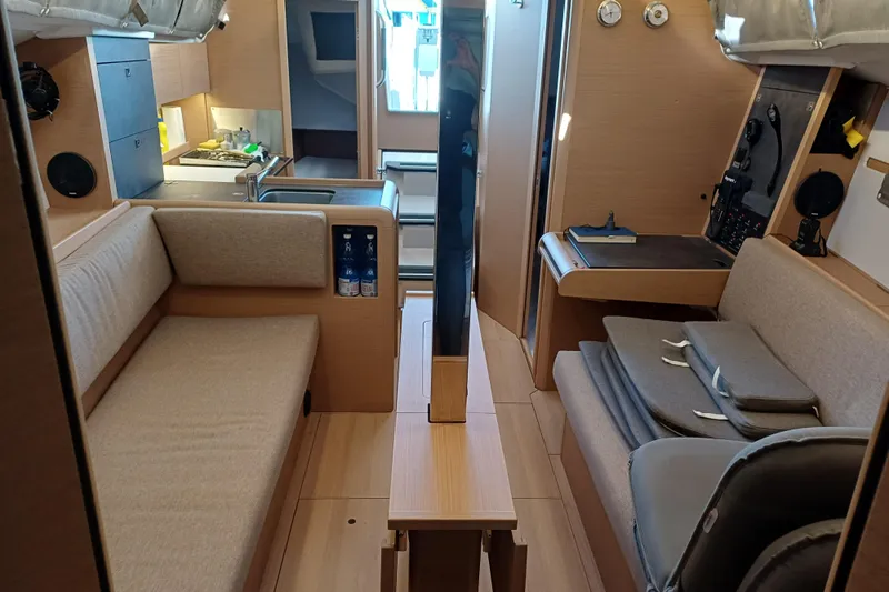 Prima Yacht Photos Pics 2024 Jeanneau Sun Odyssey 349 interior with modern kitchen and seating area.