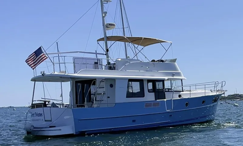 First Mates Yacht Photos Pics 2015 Beneteau Swift Trawler 44 on water, featuring blue hull and American flag.