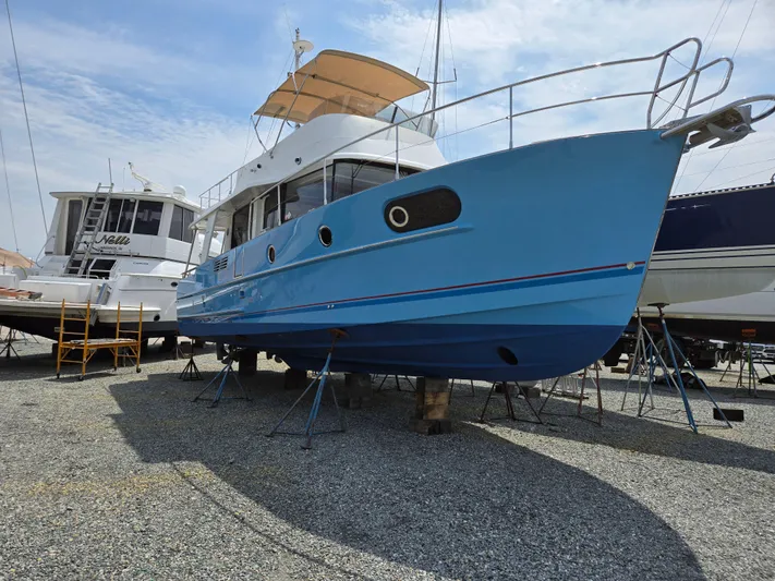 First Mates Yacht Photos Pics 2015 Beneteau Swift Trawler 44 in dry dock, blue hull, side view.