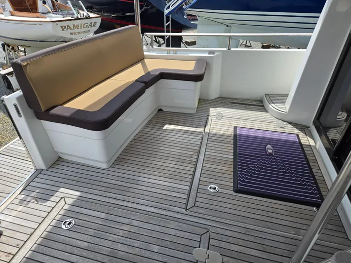 First Mates Yacht Photos Pics 2015 Beneteau Swift Trawler 44 deck with seating and teak flooring.