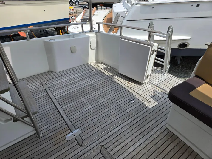 First Mates Yacht Photos Pics 2015 Beneteau Swift Trawler 44 deck with open gate and seating area.
