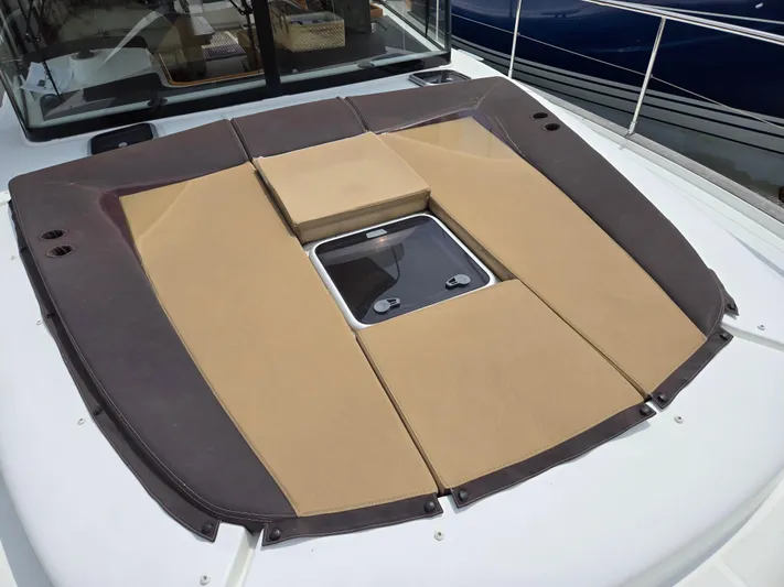 First Mates Yacht Photos Pics 2015 Beneteau Swift Trawler 44 sunpad with hatch, featuring brown and beige cushions.