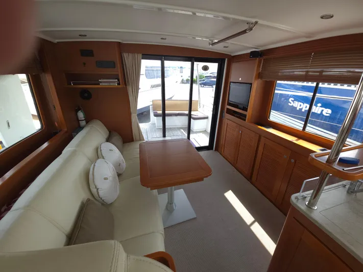 First Mates Yacht Photos Pics Interior of 2015 Beneteau Swift Trawler 44 with cozy seating and wooden accents.