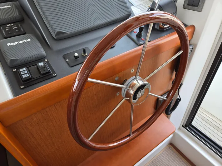 First Mates Yacht Photos Pics Steering wheel of 2015 Beneteau Swift Trawler 44 with Raymarine controls.