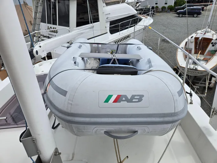 First Mates Yacht Photos Pics Inflatable boat on 2015 Beneteau Swift Trawler 44 deck, marina background.