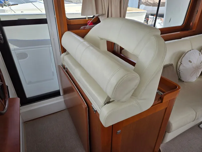 First Mates Yacht Photos Pics Interior of 2015 Beneteau Swift Trawler 44 with cream leather seating and wooden accents.