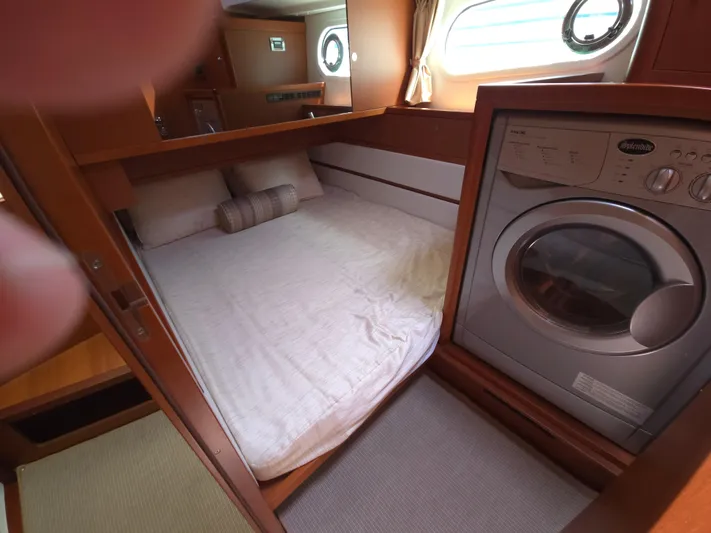 First Mates Yacht Photos Pics Interior of 2015 Beneteau Swift Trawler 44 with bed and washing machine.