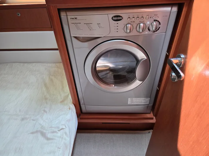First Mates Yacht Photos Pics Washing machine inside 2015 Beneteau Swift Trawler 44, wooden cabinetry, compact design.