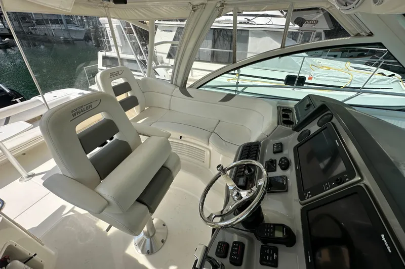  Yacht Photos Pics 2013 Boston Whaler 345 Conquest helm with modern controls and comfortable seating.